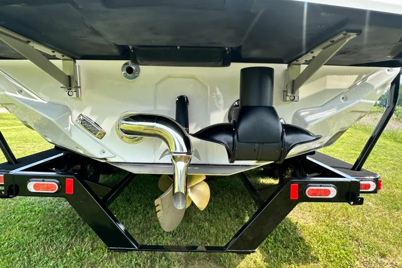Slide: The Image of 2026 Nautique Super Air Nautique GS22E boat stern with propeller and exhaust system. - 27