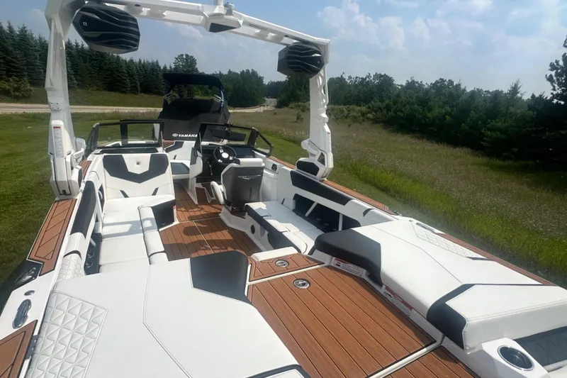 Slide: The Image of 2026 Nautique Super Air Nautique GS22E boat with sleek interior design and spacious seating. - 4