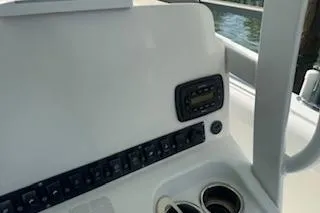 Slide: The Image of 2014 Sea Hunt Gamefish 25 dashboard with control panel and cup holders. - 13