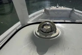Slide: The Image of 2014 Sea Hunt Gamefish 25 boat compass on deck, sunlight reflecting on water. - 14