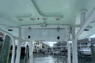 Slide: The Image of 2014 Sea Hunt Gamefish 25 boat interior with overhead storage and waterfront view. - 15