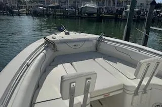 Slide: The Image of 2014 Sea Hunt Gamefish 25 boat docked at marina, featuring spacious seating area. - 18