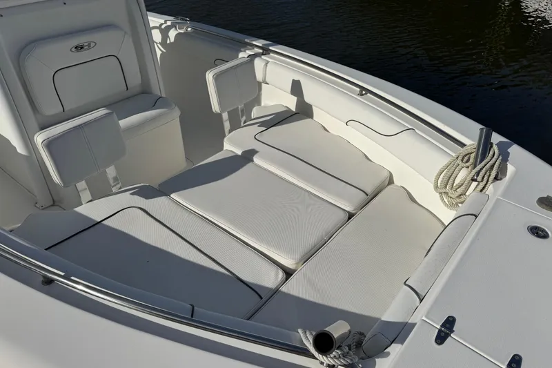 Slide: The Image of 2014 Sea Hunt Gamefish 25 boat interior with cushioned seating and coiled rope. - 19