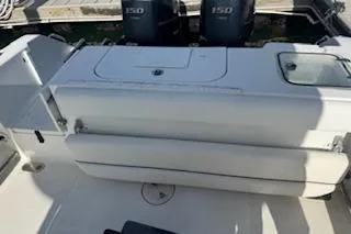 Slide: The Image of 2014 Sea Hunt Gamefish 25 boat interior with dual engines and seating area. - 5