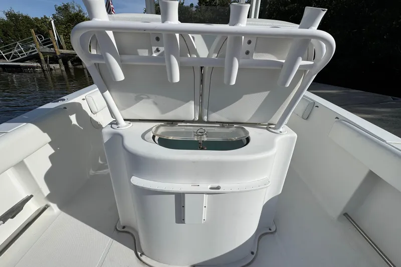 Slide: The Image of 2014 Sea Hunt Gamefish 25 boat interior with rod holders and livewell. - 7
