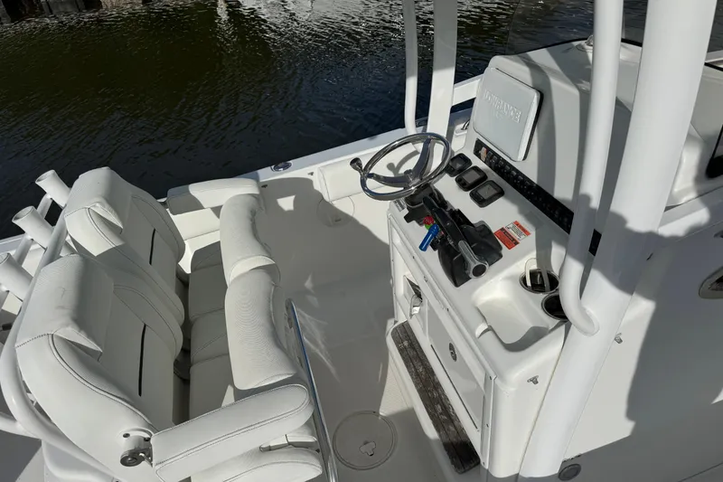Slide: The Image of 2014 Sea Hunt Gamefish 25 boat interior with steering console and seating. - 8