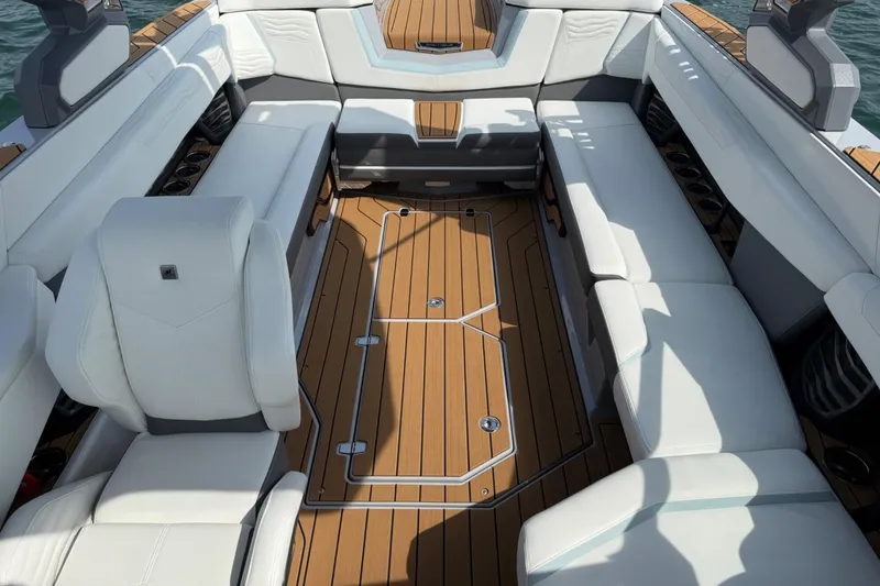 Slide: The Image of 2026 Nautique Super Air Nautique G25 interior with luxurious seating and teak flooring. - 12
