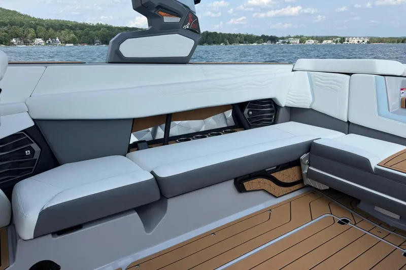 Slide: The Image of 2026 Nautique Super Air Nautique G25 interior with luxurious seating and lake view. - 3