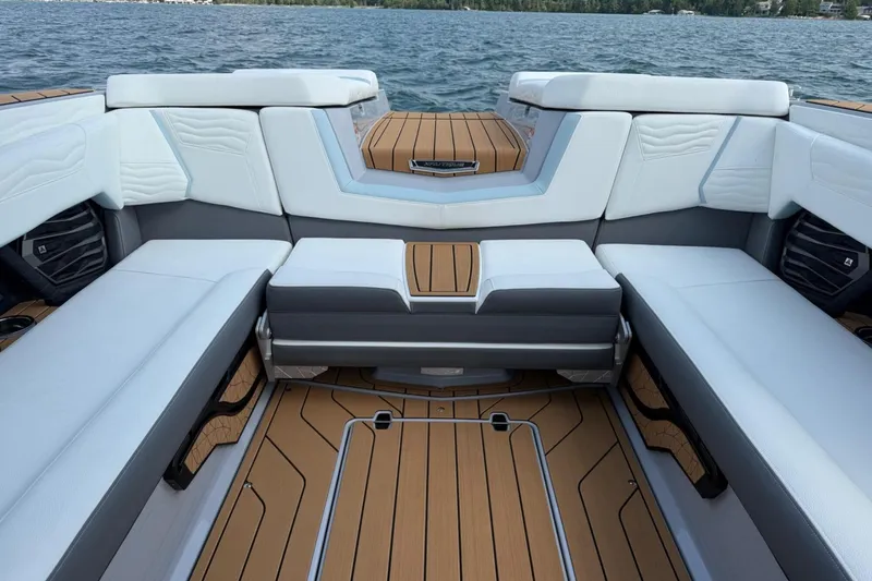 Slide: The Image of 2026 Nautique Super Air Nautique G25 interior with luxurious seating and teak flooring. - 4