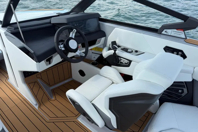 Slide: The Image of 2026 Nautique Super Air Nautique G25 cockpit with modern controls and luxurious seating. - 7