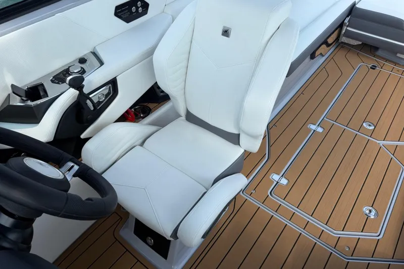 Slide: The Image of 2026 Nautique Super Air Nautique G25 interior with white seating and teak flooring. - 8