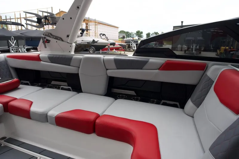 Slide: The Image of 2021 Malibu M220 boat interior with red and gray seating, showcasing modern design. - 5