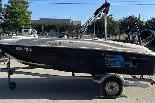 Slide: The Image of 2017 Bayliner Element E16 boat on trailer, parked outdoors. - 2