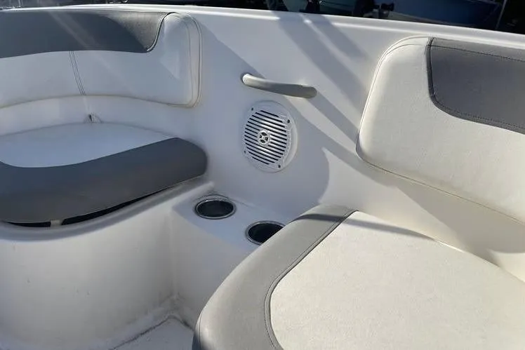 Slide: The Image of 2017 Bayliner Element E16 boat interior with cushioned seating and built-in cup holders. - 8
