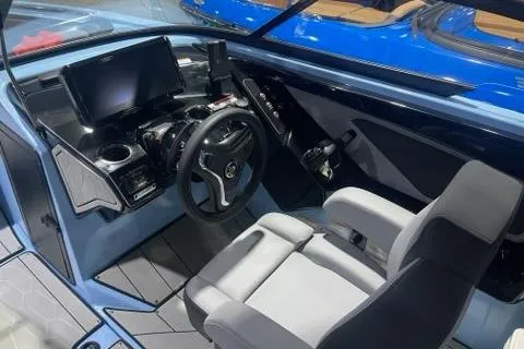 Slide: The Image of 2025 Yamaha Boats 255XD cockpit with modern steering and navigation system. - 5