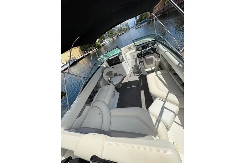 Slide: The Image of 2020 Four Winns HD240 OB boat interior with spacious seating and sleek design on a sunny day. - 11