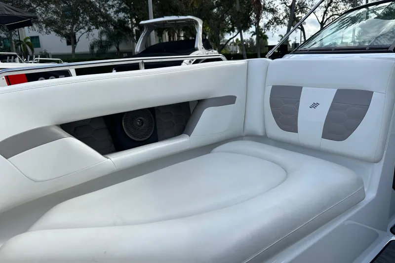 Slide: The Image of 2020 Four Winns HD240 OB boat interior with white cushioned seating and speaker. - 32
