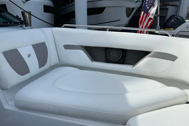 Slide: The Image of 2020 Four Winns HD240 OB boat interior with white cushioned seating and speaker. - 34