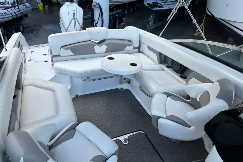 Slide: The Image of 2020 Four Winns HD240 OB boat interior with white seating and round table. - 39