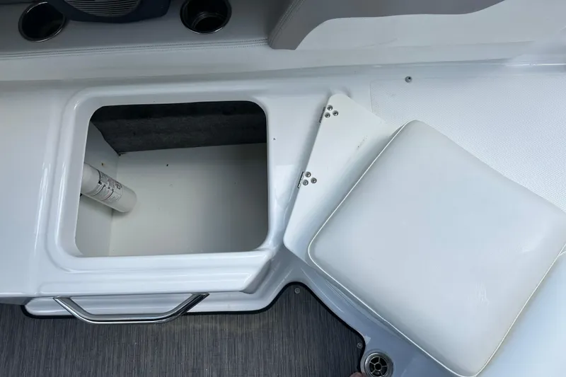 Slide: The Image of Storage compartment on 2020 Four Winns HD240 OB boat with open lid and visible fire extinguisher. - 42
