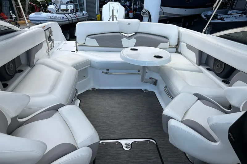 Slide: The Image of 2020 Four Winns HD240 OB boat interior with white seating and round table. - 44