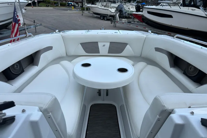 Slide: The Image of 2020 Four Winns HD240 OB boat interior with white seating and round table. - 47