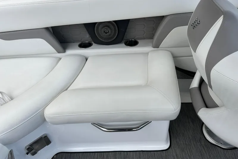 Slide: The Image of 2020 Four Winns HD240 OB boat interior with white and gray seating, cup holders, and speaker. - 52