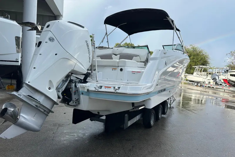 Slide: The Image of 2020 Four Winns HD240 OB boat with Mercury outboard engine, parked on a trailer. - 59