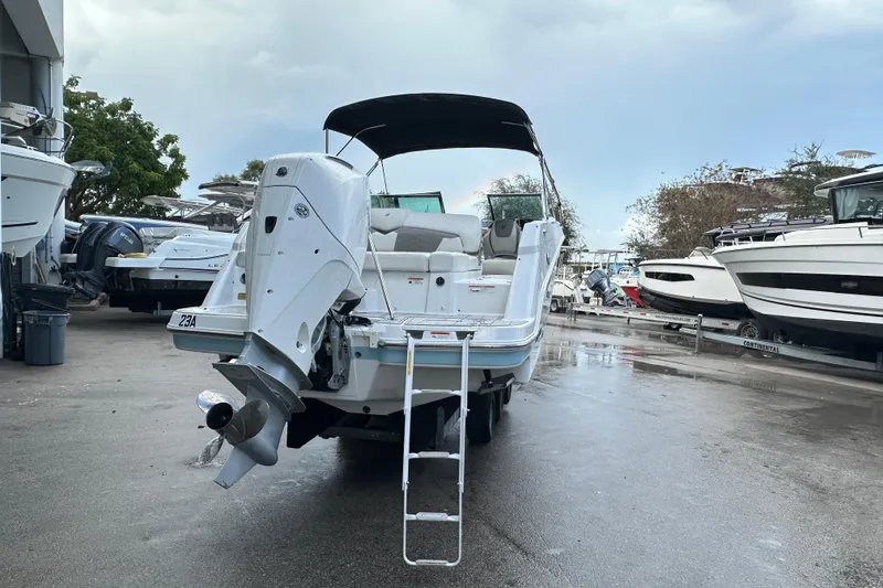 Slide: The Image of 2020 Four Winns HD240 OB boat with outboard motor, docked in a marina. - 62