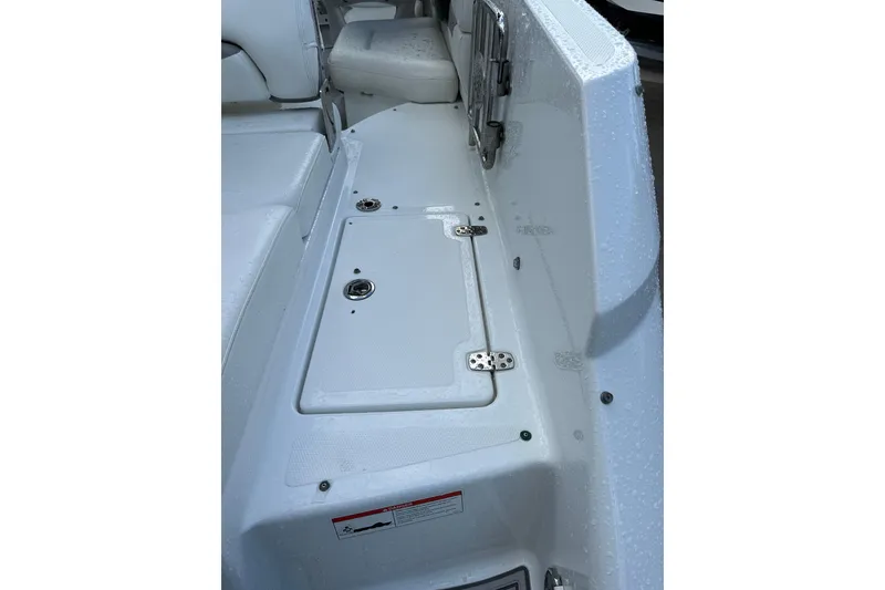 Slide: The Image of 2020 Four Winns HD240 OB boat interior with seating and storage compartment. - 70