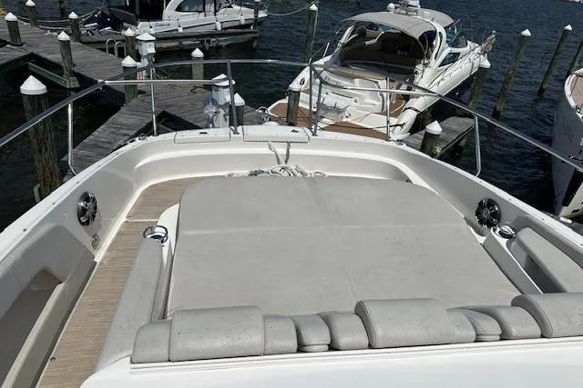 Slide: The Image of 2021 Sea Ray Sundancer 320 yacht docked, featuring spacious sunbathing area and sleek design. - 7