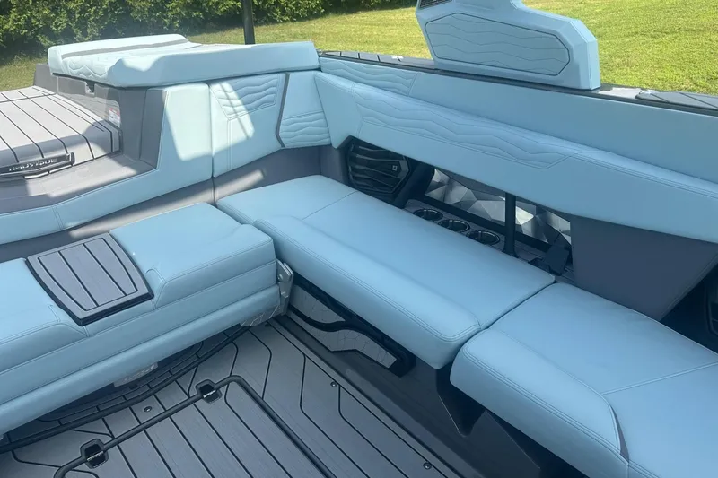 Slide: The Image of 2026 Nautique Super Air Nautique G23 interior with light blue seating and modern design. - 12