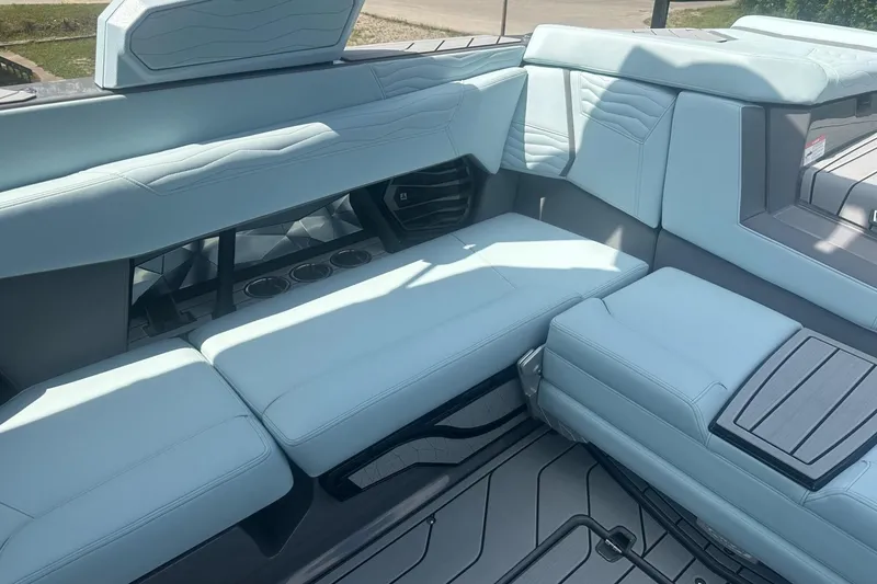 Slide: The Image of 2026 Nautique Super Air Nautique G23 interior with light blue seating and cup holders. - 13
