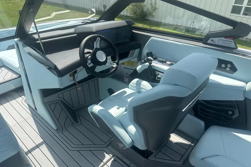 Slide: The Image of Interior of 2026 Nautique Super Air Nautique G23 boat, featuring modern helm and seating. - 15