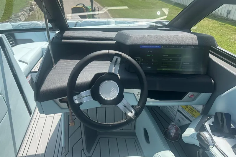Slide: The Image of 2026 Nautique Super Air Nautique G23 cockpit with modern steering and digital display. - 17