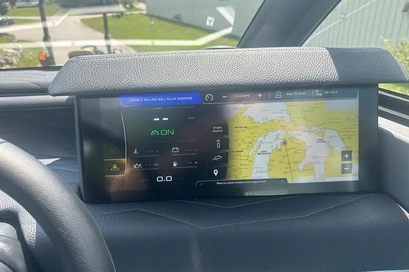 Slide: The Image of 2026 Nautique Super Air Nautique G23 dashboard with navigation display and control interface. - 18