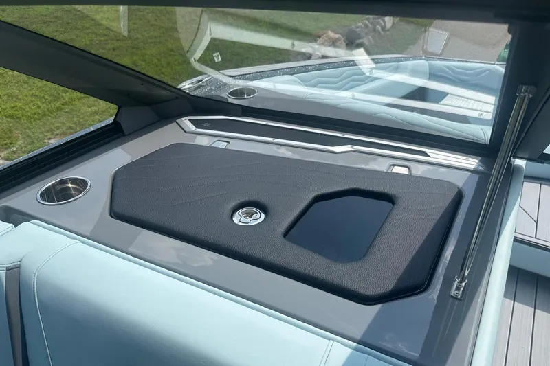 Slide: The Image of 2026 Nautique Super Air Nautique G23 interior detail with cup holders and sleek design. - 24