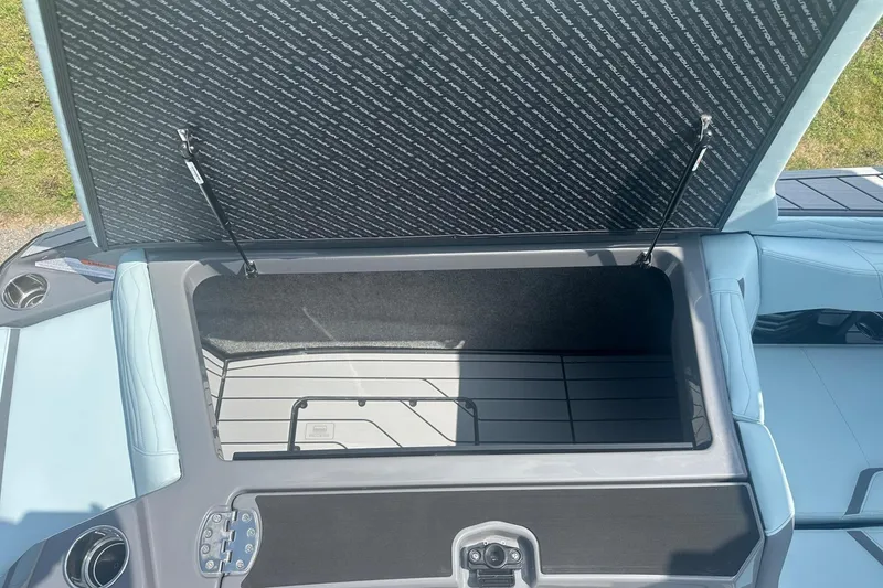 Slide: The Image of Open storage compartment in 2026 Nautique Super Air Nautique G23 boat. - 26