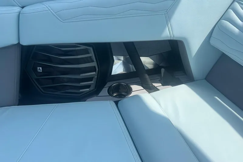 Slide: The Image of 2026 Nautique Super Air Nautique G23 interior with speaker and cup holder detail. - 28