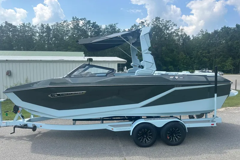 Slide: The Image of 2026 Nautique Super Air Nautique G23 boat on trailer, parked outdoors under a cloudy sky. - 3