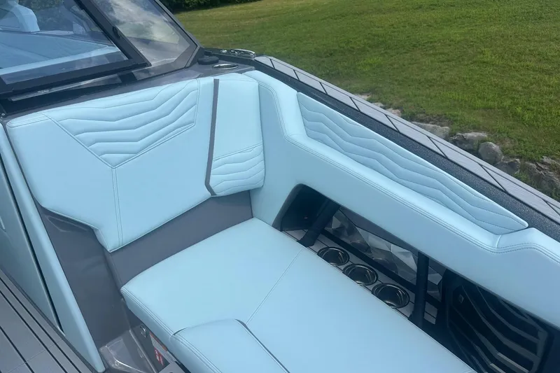 Slide: The Image of 2026 Nautique Super Air Nautique G23 interior with light blue seating and cup holders. - 33
