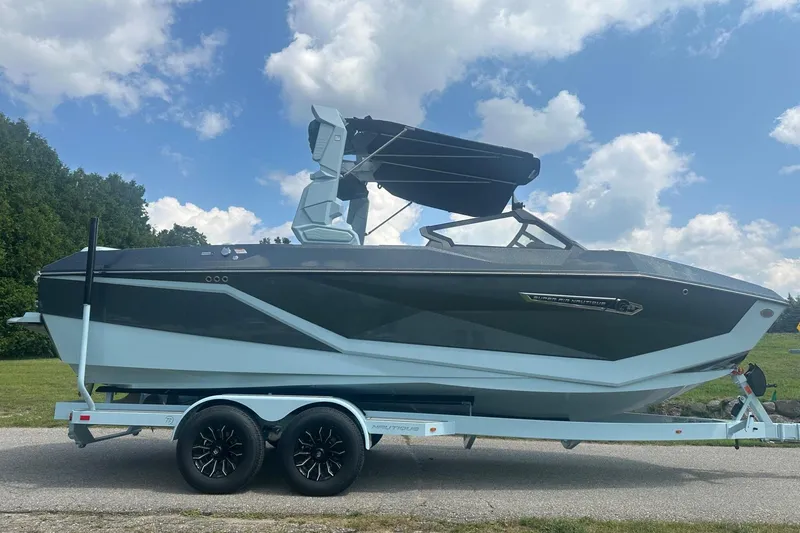 Slide: The Image of 2026 Nautique Super Air Nautique G23 boat on trailer under blue sky. - 7