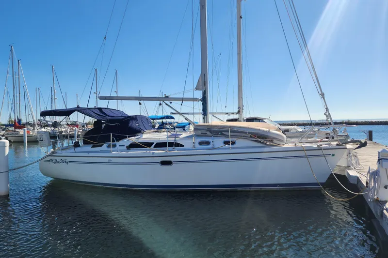 The Image of 2004 Catalina 350 sailboat docked at marina under clear blue sky. - 0