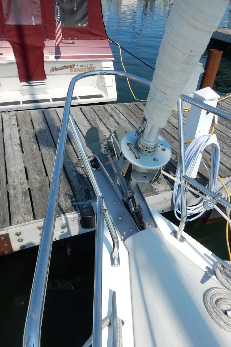 Slide: The Image of 2004 Catalina 350 sailboat docked, showing deck and rigging details. - 13