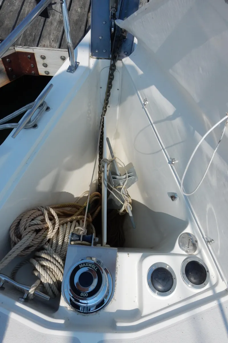 Slide: The Image of 2004 Catalina 350 sailboat anchor locker with ropes and winch. - 14