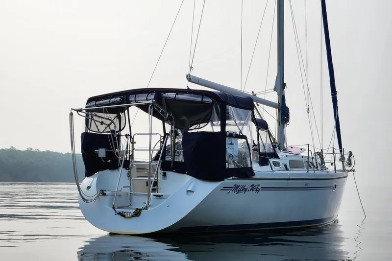 Slide: The Image of Catalina 350 sailboat from 2004 on calm water, featuring a sleek design and canopy. - 16