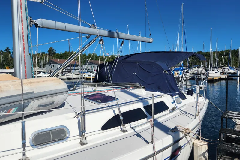 Slide: The Image of 2004 Catalina 350 sailboat docked at marina under clear blue sky. - 2