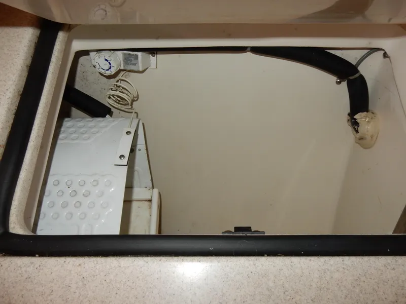 Slide: The Image of 2004 Catalina 350 boat interior compartment with wiring and tubing. - 25