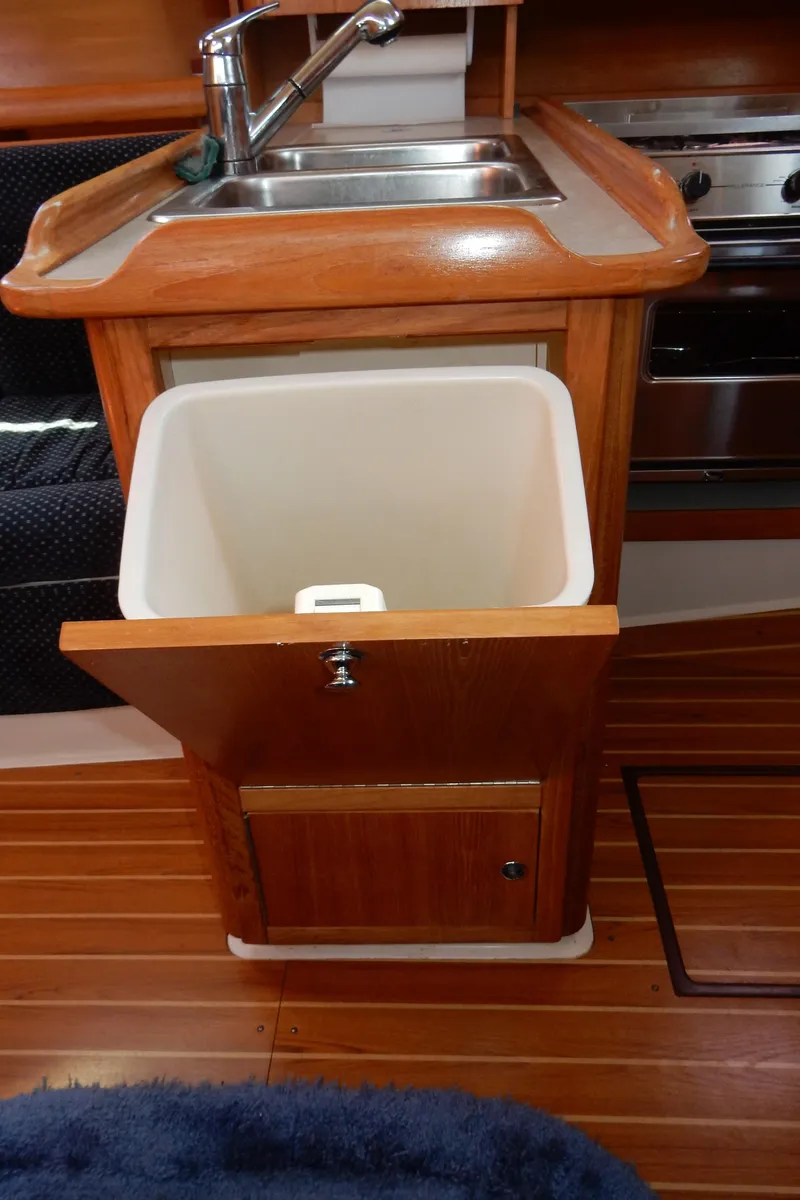Slide: The Image of Catalina 350 yacht kitchen with sink and open storage, 2004 model. - 28
