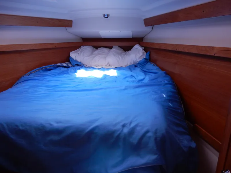 Slide: The Image of Cozy cabin bed with blue bedding in a 2004 Catalina 350 sailboat. - 36